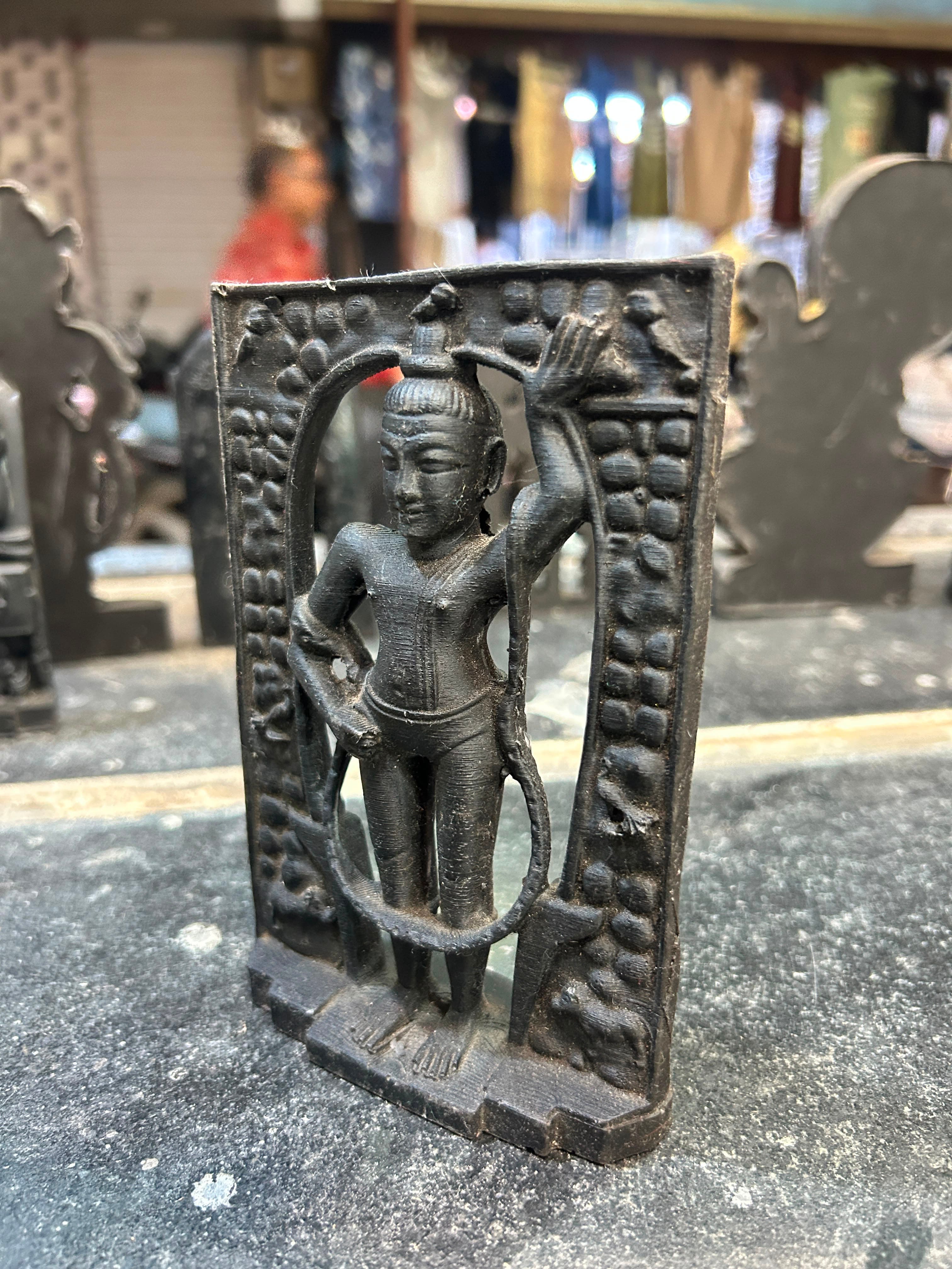Artisan adding fine details to a divine murti